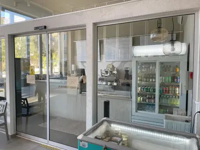a kitchen with a refrigerator with drinks in it at Domino Blue Apartment in Paralimni