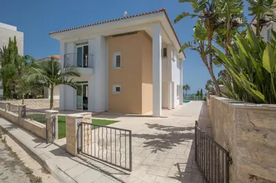 a villa with a gate in front of a house at Shaye Front Line Villa in Protaras