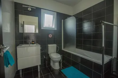 a bathroom with a toilet and a shower and a sink at Broadway Villas in Protaras