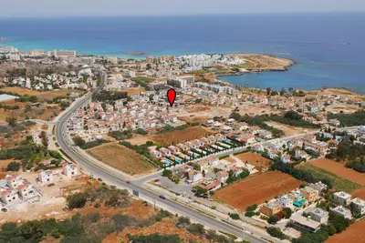 a red kite flying over a city with a road at Halle Villa in Protaras