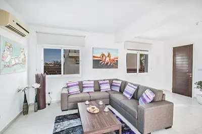 a living room with a couch and a table at Halle Villa in Protaras