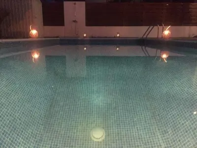 an empty swimming pool with lights in it at Sol y Mar Malama Villa in Paralimni