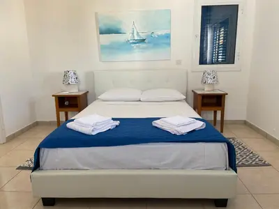 a bedroom with a bed with two towels on it at Sol y Mar Malama Villa in Paralimni