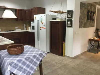 a kitchen with a table and a white refrigerator at Galaria House in Moutoullas