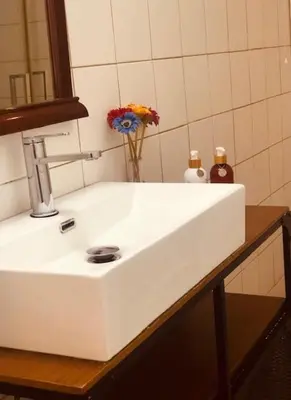 a white sink with flowers in a bathroom at Galaria House in Moutoullas