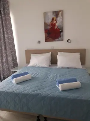 a bedroom with a bed with two towels on it at P L Sunorama Beach Garden 302 in Larnaka