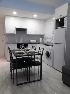 a kitchen with a table and chairs in a kitchen at P L Sunorama Beach Garden 302 in Larnaka