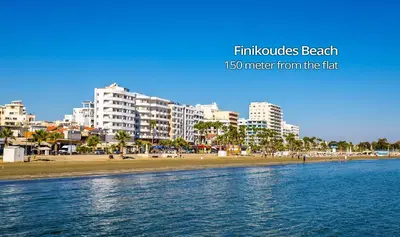 a view of a beach with buildings in the background at Paradise Palms Seaview Apartment in Larnaka