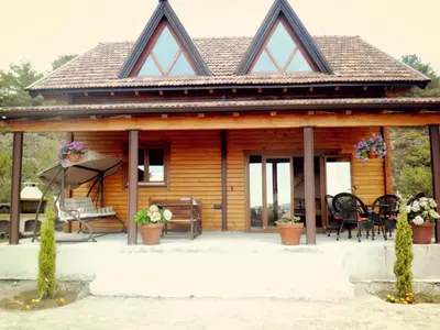 a log cabin with a porch and a patio at Agros Timber Log House in Agros