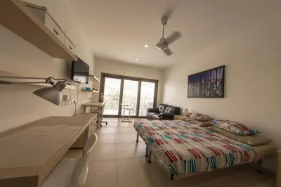 a bedroom with a bed and a living room at Olivier Residence in Nicosia