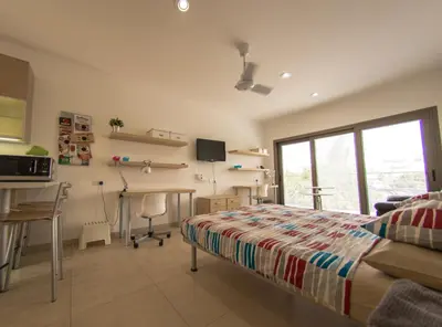 a bedroom with a bed and a desk and a table at Olivier Residence in Nicosia