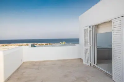 a white house with a view of the ocean at Leana Front Line Villa in Protaras