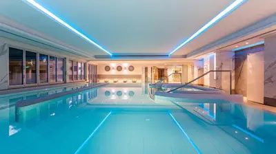 a swimming pool in a hotel with blue lighting at Crowne Plaza Limassol by IHG in Limassol