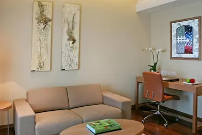 a living room with a couch and a desk at Crowne Plaza Limassol by IHG in Limassol