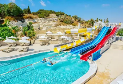 a water slide in a pool at a resort at Louis St. Elias Resort & Waterpark in Protaras