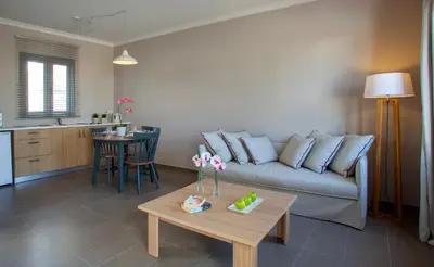 a living room with a couch and a table at Louis St. Elias Resort & Waterpark in Protaras