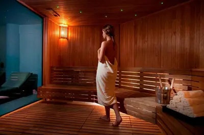 a woman standing in front of a wooden bench at Royal Apollonia by Louis Hotels in Limassol