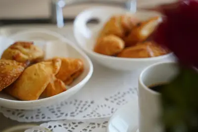 two bowls of food on a table with a cup of coffee at Ajax Hotel in Limassol