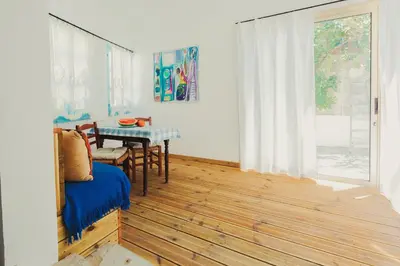 a living room with a table and a dining room at Archondia House - Holiday Apartments With Pool in Kalavasos