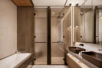 a bathroom with two sinks and a tub and a shower at Amathus Beach Hotel Limassol in Limassol