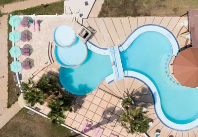 an overhead view of a pool at a resort at Astreas Beach Hotel Apartments in Protaras