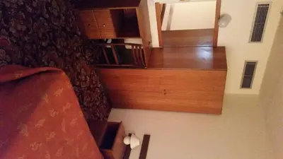 a stairway in a room with wooden furniture at Sylva Hotel in Limassol