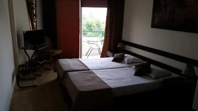a hotel room with a bed and a window at Sylva Hotel in Limassol