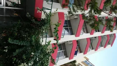 an apartment building with red ribbon at Sylva Hotel in Limassol