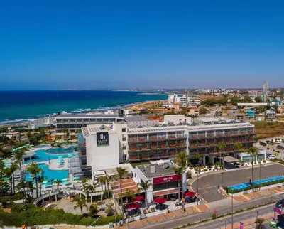 an aerial view of a resort and the ocean at Faros Hotel Ayia Napa in Ayia Napa