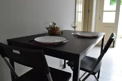 a black table with two wine glasses and a plate on it at Chris House in Nicosia