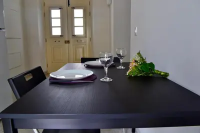 a black table with two glasses and a plate at Chris House in Nicosia