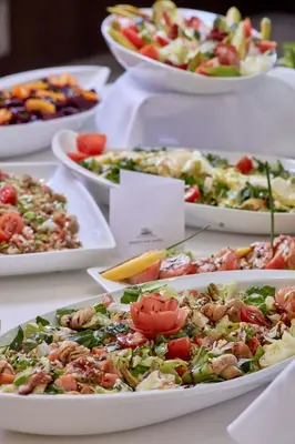 a table with many plates of different types of food at Grecian Bay in Ayia Napa