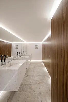 a bathroom with four sinks and a row of mirrors at Grecian Sands Hotel in Ayia Napa