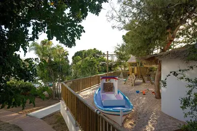 a toy boat on the sand in a playground at Grecian Sands Hotel in Ayia Napa