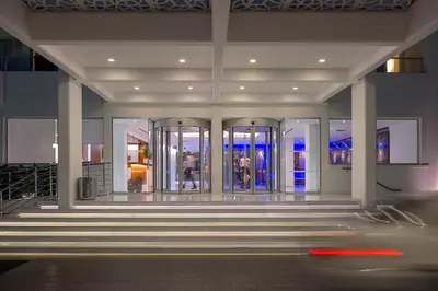 a lobby of a building with stairs and windows at Grecian Sands Hotel in Ayia Napa