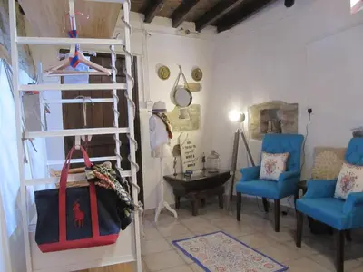 a room with a loft bed and two blue chairs at Stratos ArtDeco House in Kalavasos