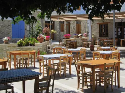 a group of tables and chairs in front of a building at Stratos ArtDeco House in Kalavasos