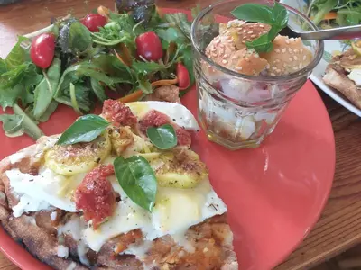 a red plate with a pizza and a salad at Stratos ArtDeco House in Kalavasos