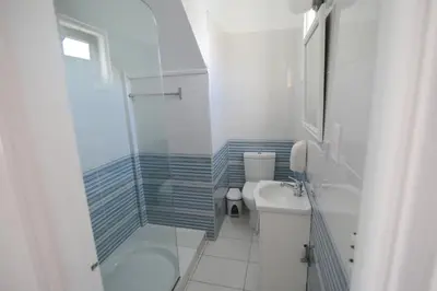 a bathroom with a shower and a toilet and a sink at Lantiana Napa Aparthotel in Ayia Napa