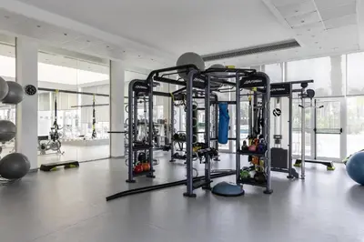 a gym with several tread machines in a room at Hilton Nicosia in Nicosia