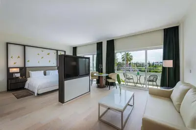 a hotel room with a bed and a tv at Hilton Nicosia in Nicosia