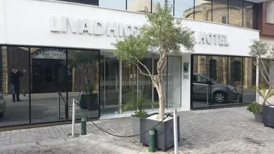 a tree in front of a nissan dealership at Livadhiotis City Hotel in Larnaka