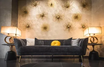 a couch in a room with flowers on the wall at Rise Urban Art Hotel in Larnaka