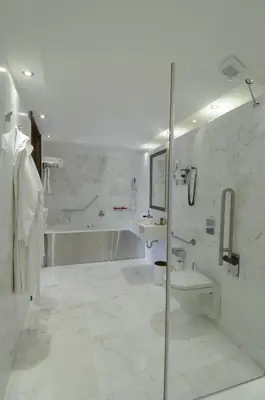 a white bathroom with a shower and a sink at The Library Hotel Wellness Retreat in Kalavasos