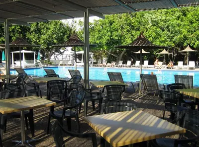 a group of tables and chairs next to a swimming pool at Marina Hotel in Ayia Napa