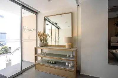 a dressing room with a mirror on a shelf at Les Palmiers Beach Boutique Hotel & Luxury Apartments in Larnaka