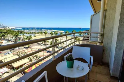 a balcony with a table and a view of the beach at Les Palmiers Beach Boutique Hotel & Luxury Apartments in Larnaka