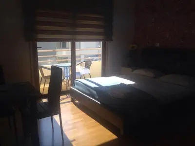 a bedroom with a bed and a view of a balcony at Les Palmiers Beach Boutique Hotel & Luxury Apartments in Larnaka