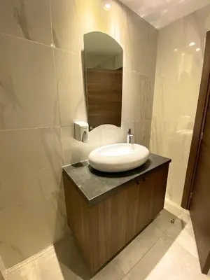 a bathroom with a sink and a mirror at Eleonora Hotel Apartments in Larnaka