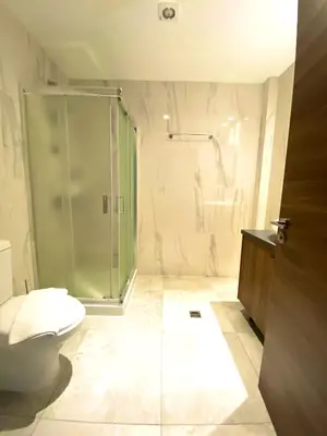 a bathroom with a glass shower and a toilet at Eleonora Hotel Apartments in Larnaka
